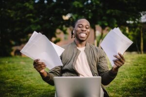 Student researching scholarships he qualifies for using a laptop